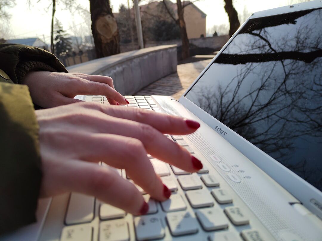 mystery writer typing on laptop
